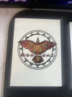 Red and yellow bird emblem featuring a skeletal crow from Kitchen Sink Press Kitchen Sink