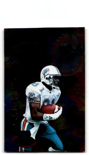 O.J. McDuffie holding football in 1996 Playoff Illusions original gloss card image