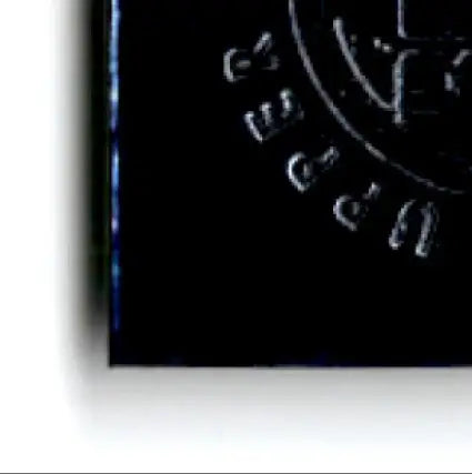 Black shiny circular object with embossed lettering from 1996 Upper Deck Racing Road to the Cup Brett Bodine RC19a