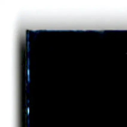 Corner of a dark glossy screen with faint blue edge from 1996 Upper Deck Racing Road to the Cup Brett Bodine RC19a