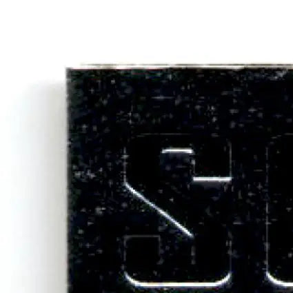 Black textured rectangular object with metallic sheen from Upper Deck Racing Road to the Cup Joe Nemechek card