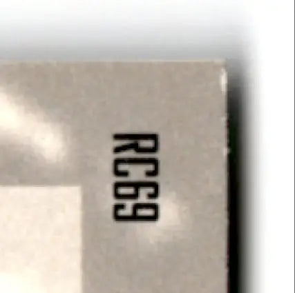 Beige rectangular object with worn edge from 1996 Upper Deck Racing Road to the Cup Rick Mast