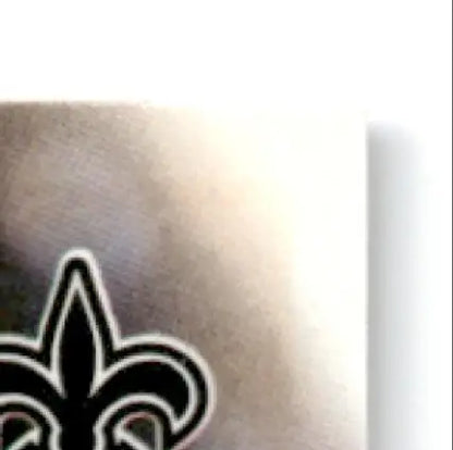 Partial view of a New Orleans Saints fleur-de-lis logo on brushed metal for Leaf Football Heath Shuler