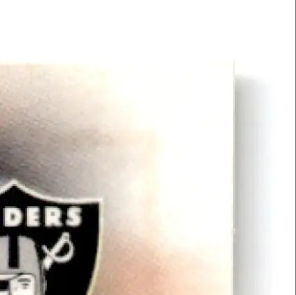 Black and white shield-shaped logo part on 1997 Leaf Football Tim Brown #144 Oakland Raiders card