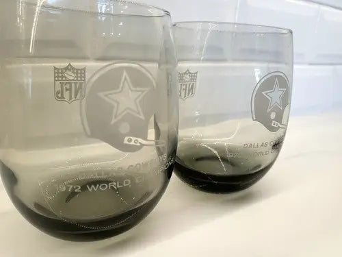 Two Dallas Cowboys smoke gray glasses from 1972 World Champions NFL merchandise