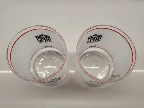 Two Vintage NFL Mobil drinking glasses featuring the St. Louis Cardinals logo
