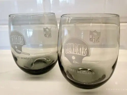 Two Cincinnati Bengals smoked glass tumblers showcasing vintage team logos