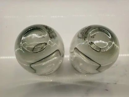 Two decorative smoked glass spheres from Cincinnati Bengals tumblers set