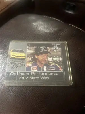 Racing card featuring driver and car from 2001 Press Pass Optima Performance Dale Earnhardt