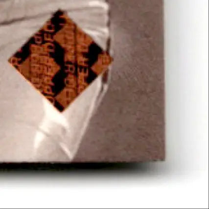 Peeling orange and black diamond sticker on a brown package for Upper Deck Football MVP Jerry Rice