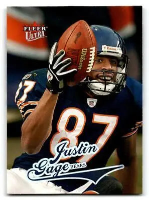 Justin Gage holding a football for the 2004 Ultra trading card collectible