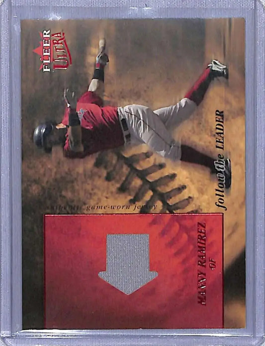 Baseball trading card of Manny Ramirez in red and gray uniform making a diving catch