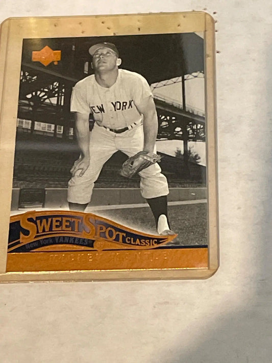 Vintage baseball card featuring New York Yankees player in batting stance, trading cards