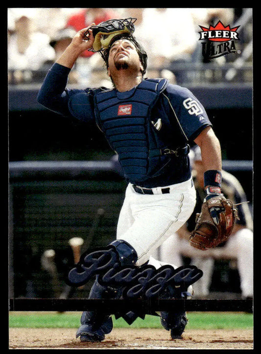 Baseball catcher in San Diego Padres gear, highlighting Mike Piazza baseball card