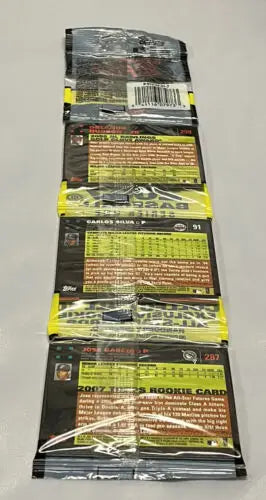 Stack of unopened 2007 Topps Baseball card packs featuring Pudge Rodriguez, Chipper Jones, Zach Duke