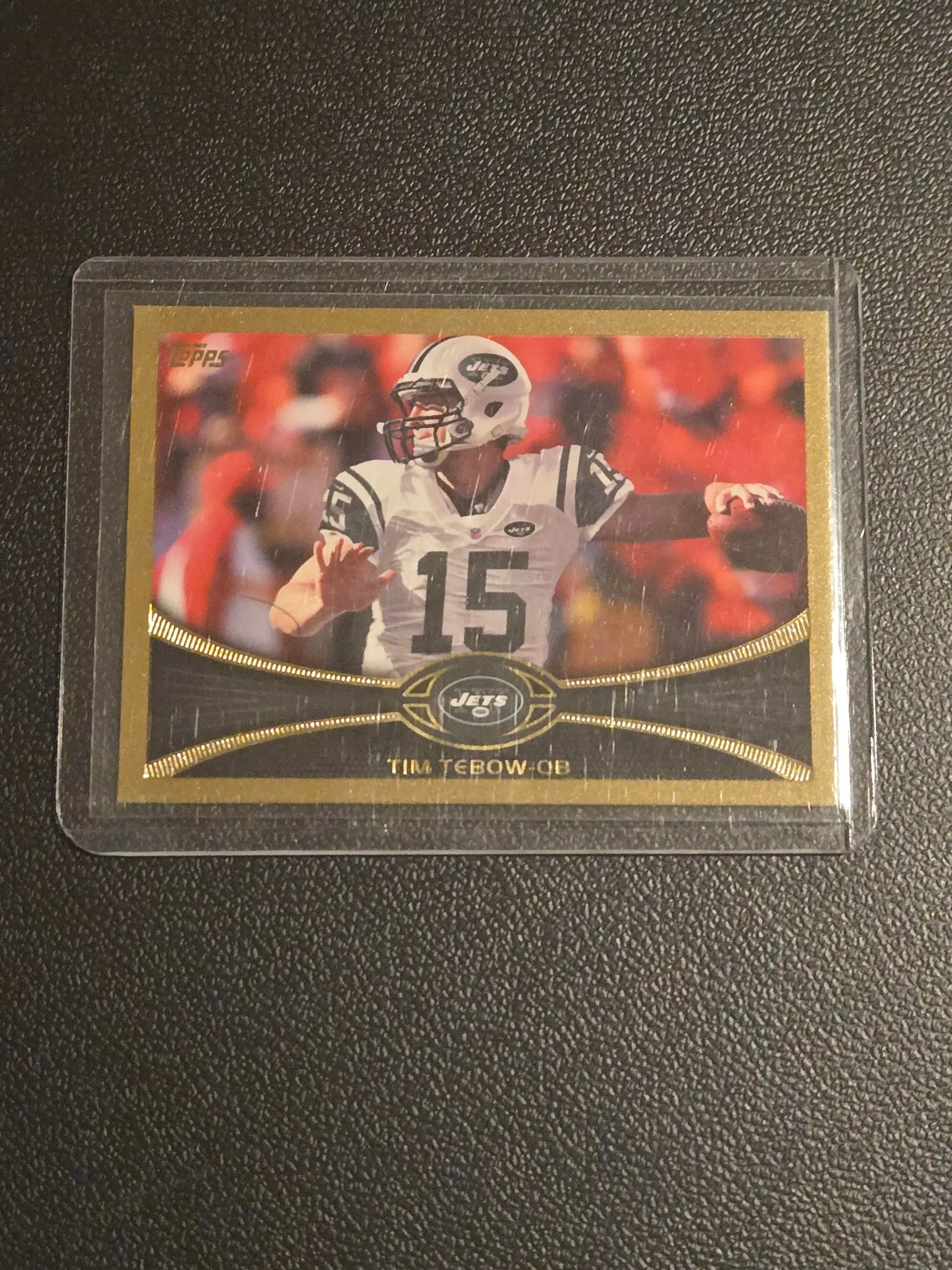 Tim Tebow Gold football trading card in protective sleeve from 2012 Topps series