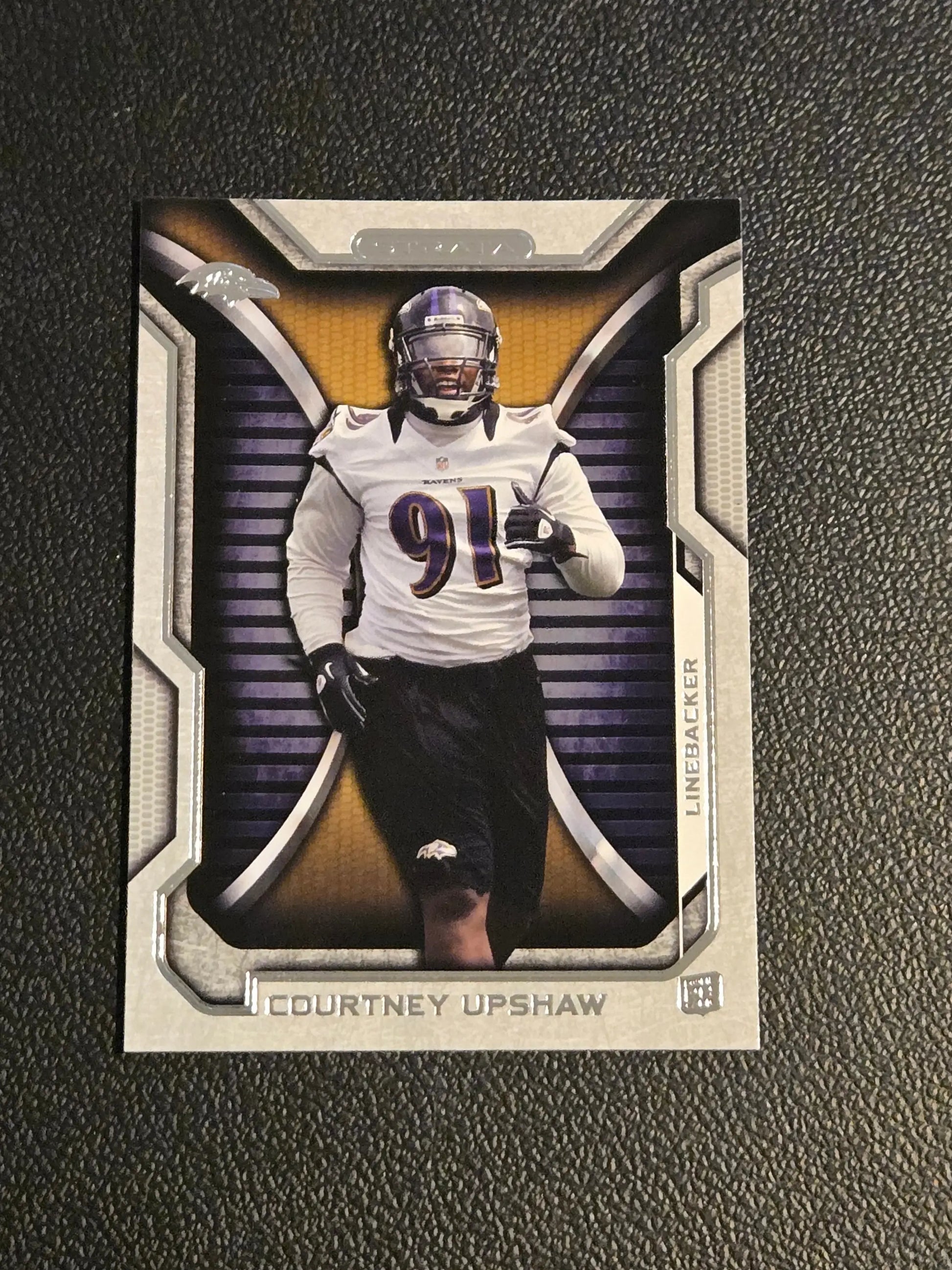 Football trading card featuring Courtney Upshaw in Baltimore Ravens uniform from Topps Strata