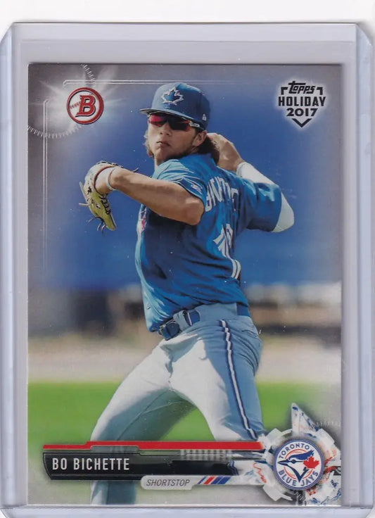 Baseball card of Bo Bichette mid-throw for Topps Holiday Toronto Blue Jays