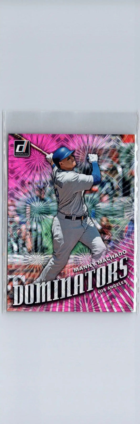 Manny Machado Dominators pink baseball card with player swinging bat against colorful background