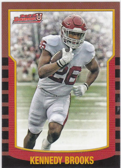 Football player in white uniform running with ball for Bowman University Kennedy Brooks Retro Insert