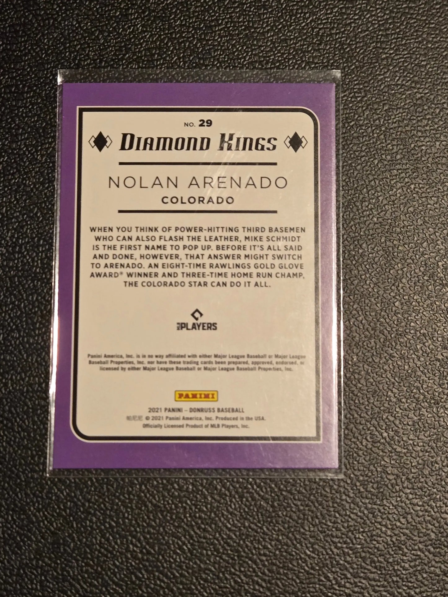Purple-bordered Nolan Arenado baseball card in protective sleeve from 2021 Donruss #29
