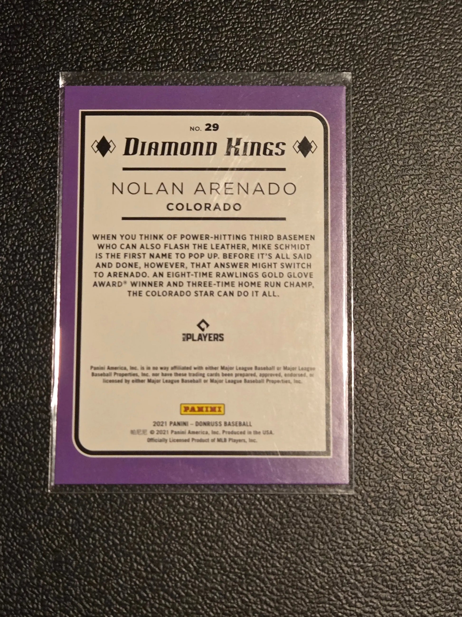 Purple-bordered Nolan Arenado baseball card in protective sleeve from 2021 Donruss #29