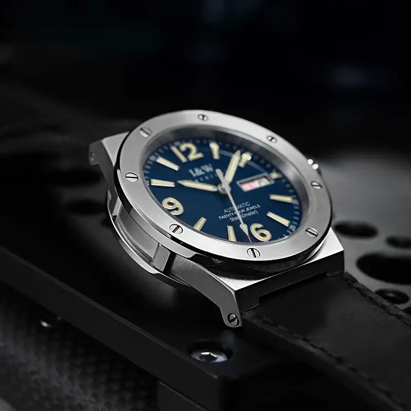 Silver-cased luxury Swiss I&W mechanical watch with deep blue dial, luminous hands, leather band, 50M water resistance