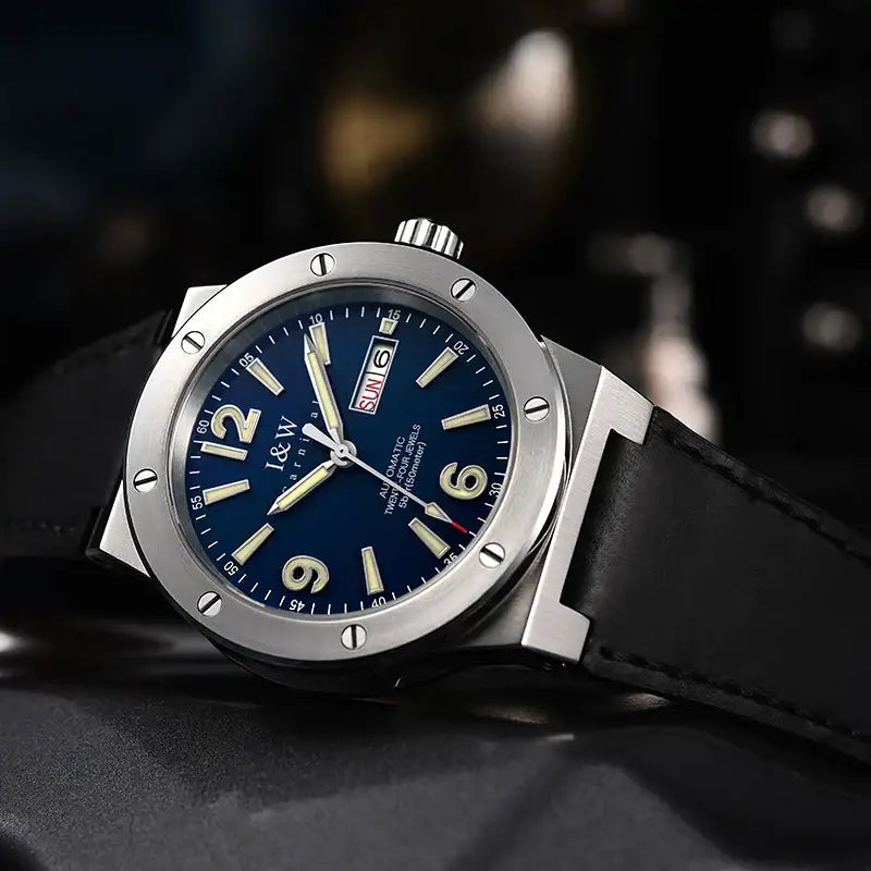 Men’s silver-toned stainless steel watch with blue dial, luminous hands, leather band, 50M water resistance