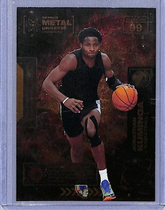 Basketball card of Jonathan Kuminga dribbling in black jersey from Skybox Metal Universe