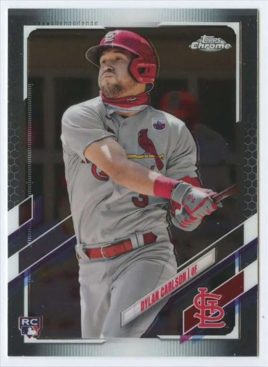 Chrome baseball card of Dylan Carlson mid-swing in St. Louis Cardinals road uniform