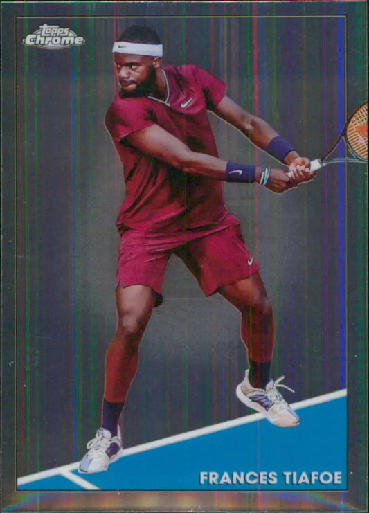Frances Tiafoe in red attire hitting a backhand shot on Topps Chrome tennis card