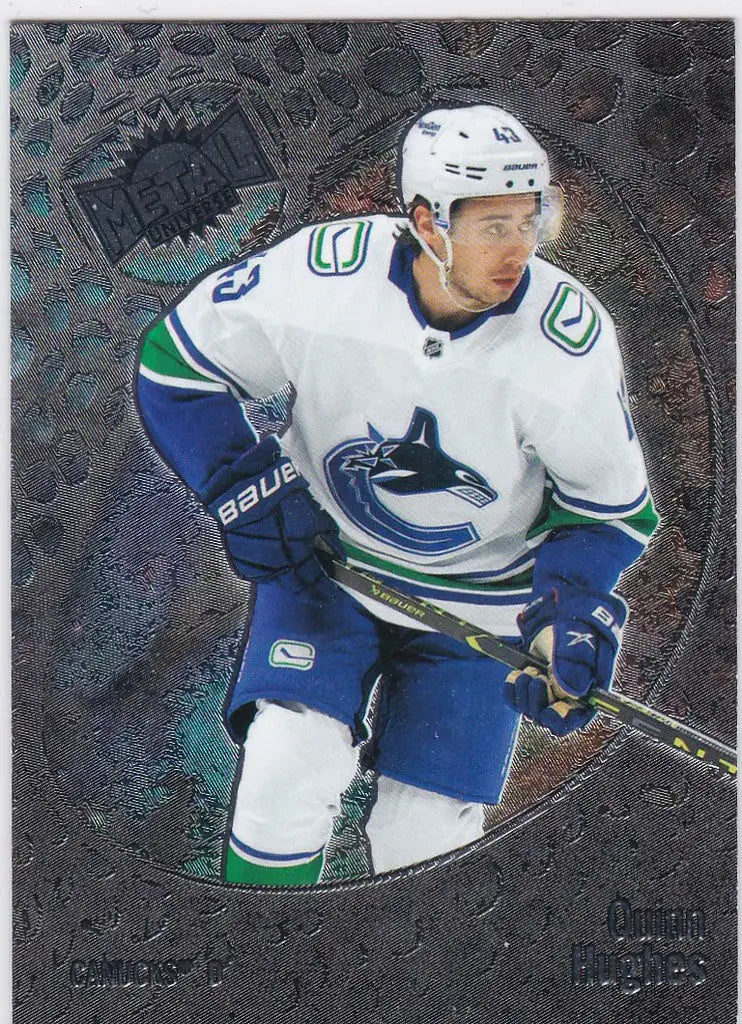 Ice hockey player in Vancouver Canucks jersey with stick, Quinn Hughes Skybox Metal Universe