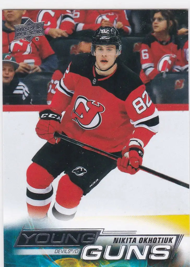 Ice hockey player in red New Jersey Devils jersey 82, Nikita Okhotiuk Young Guns card