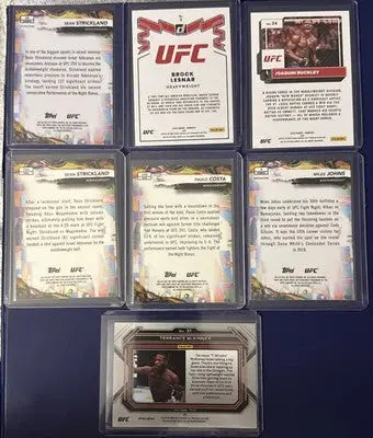 UFC trading card lot in protective cases featuring rookies, vets, Prizm, Refrac, and Base