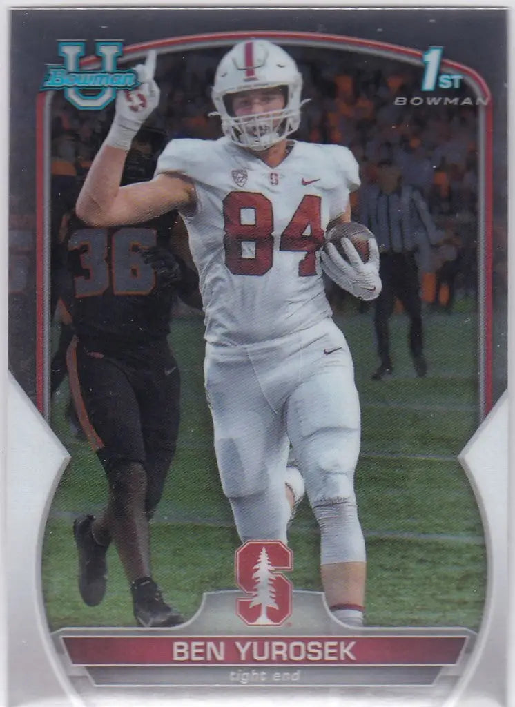 Football player in white uniform with number 84 running, showcasing Ben Yurosek Bowman 1st