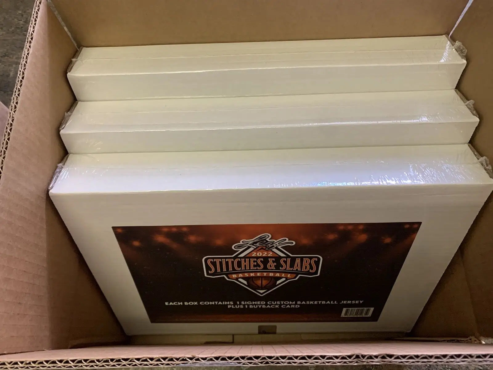 Box of wrapped basketball jerseys from 2022 Leaf Stitches basketball hobby box