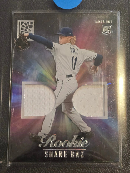 Baseball trading card of Shane Baz rookie with dual game-worn jersey swatches