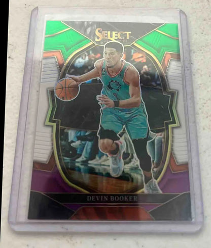 Basketball trading card of Devin Booker Green from Panini Select Devin series in protective sleeve