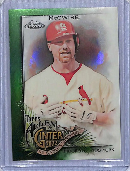 Baseball card of Mark McGwire in white uniform, red cap, green refractor #/99