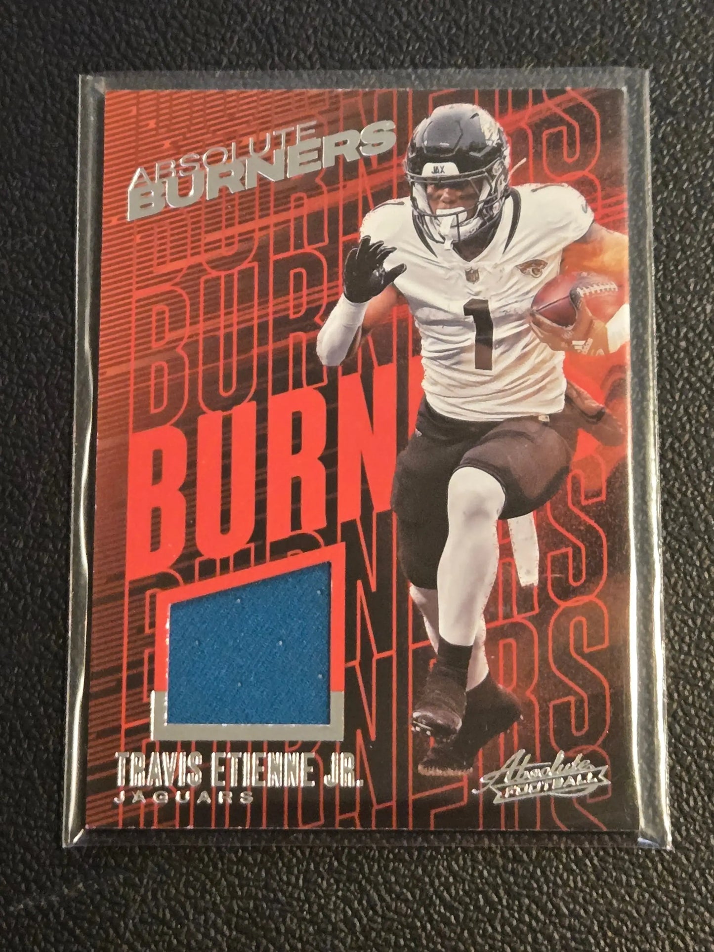 Travis Etienne Jr. football trading card with jersey swatch from Panini Absolute Absolute Burners