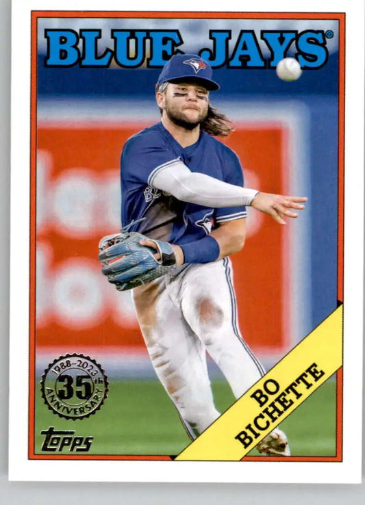 Toronto Blue Jays player Bo Bichette in navy uniform throwing a baseball