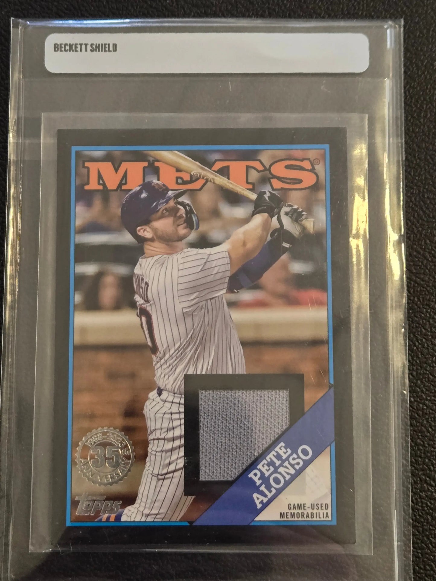 Graded Pete Alonso baseball card with game-used memorabilia swatch from 2023 Topps Pete Alonso 1988 Topps Baseball 35th Anniversary Relics Black