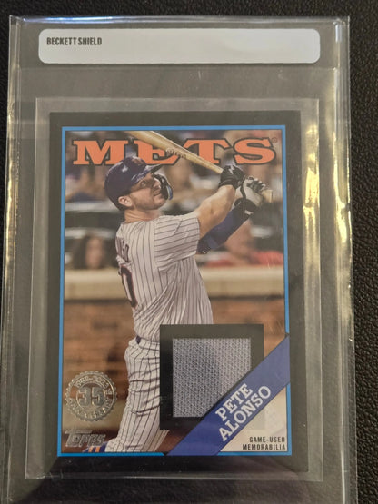 Graded Pete Alonso baseball card with game-used memorabilia swatch from 2023 Topps Pete Alonso 1988 Topps Baseball 35th Anniversary Relics Black