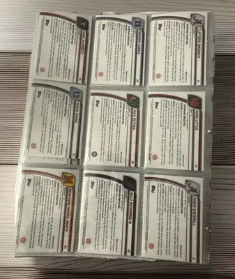 Binder page with nine Bowman Chrome baseball cards showing reverse sides with stats