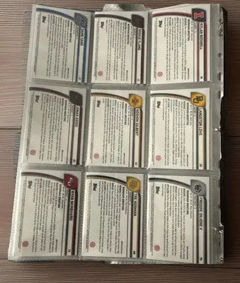 Binder page with nine Bowman Chrome baseball cards featuring player info, ideal for basketball trading collections