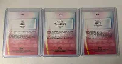 Three sports trading cards in protective sleeves featuring Drake Maye and image insert