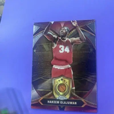 Collectible Hakeem Olajuwon blue basketball refractor card in red jersey with number 34