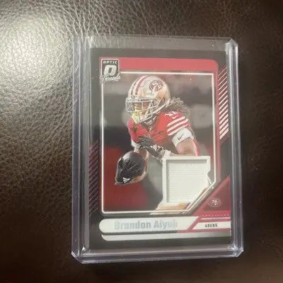Football trading card featuring Brandon Aiyuk with jersey swatch from 2024 Donruss Optic Donruss Threads