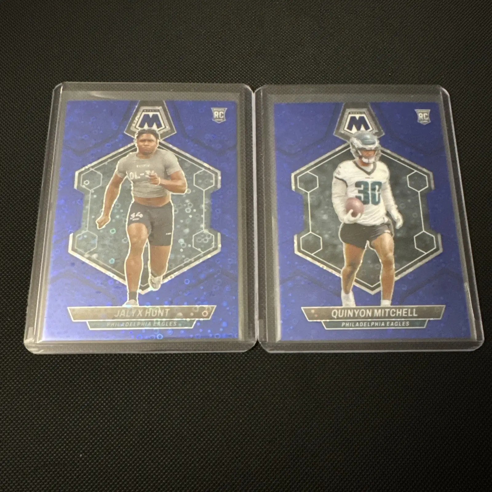 Two football trading cards featuring 2024 Mosaic Eagles Rookie Blue Disco Lot /75