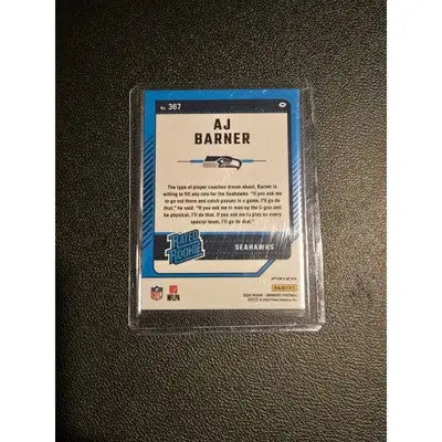 Encased AJ Barner football card with pink refractor from Panini Donruss Optic 2024 draft lot
